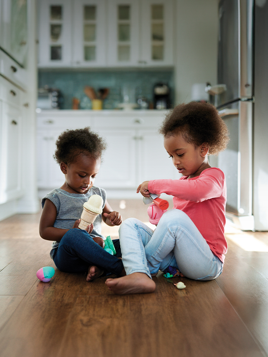 Woman sitting on hardwood flooring
